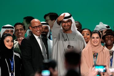 United Nations Climate Chief Simon Stiell, left, and COP28 President Sultan al-Jaber pose for photos at the end of the COP28 U.N. Climate Summit, Wednesday, Dec. 13, 2023, in Dubai, United Arab Emirates. (AP)