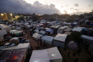 Palestinians displaced by the Israeli bombardment of the Gaza Strip are seen in tents in town of Khan Younis, Wednesday, Dec. 13, 2023. (AP)