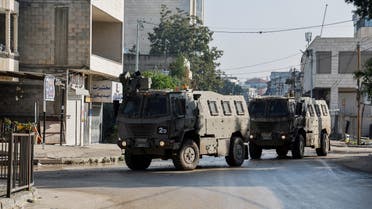 Israeli military vehicles manoeuvre on a road during a raid in Jenin, amid the ongoing conflict between Israel and the Palestinian Islamist group Hamas, in the Israeli-occupied West Bank, December 12, 2023. REUTERS/Raneen Sawafta