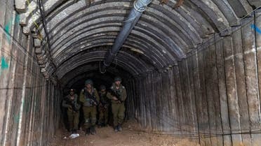 Israeli soldiers walk through what Israel’s military says is an iron-girded tunnel designed by Hamas to disgorge carloads of Palestinian fighters for a surprise storming of the border, amid the Israeli army’s ongoing ground operation against Hamas, close to Erez crossing in the northern Gaza Strip, December 15, 2023. (Reuters)