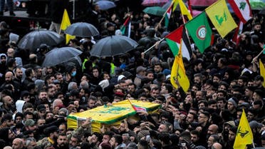 Mourners march with the bodies of three fighters of the Lebanese Shia movement Hezbollah killed in an Israeli raid in Quneitra in southwestern Syria along the Golan Heights, during the funeral in Beirut's southern suburb on December 9, 2023. (File photo: AFP)