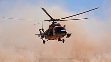 An Iraqi military helicopter lands near the al-Qaim border crossing between Syria and Iraq on November 1, 2018. Iraqi troops reinforced their positions along the porous frontier with neighbouring war-torn Syria, fearing a spillover from clashes there between Islamic State group and US-backed forces. (Photo by MOADH AL-DULAIMI / AFP)