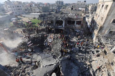 Palestinians gather at the site of an Israeli strike on a house, amid the ongoing conflict between Israel and Hamas, in Rafah, in the southern Gaza Strip, on December 19, 2023. (Reuters)