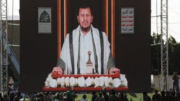 Houthi leader Abdel-Malek al-Houthi delivers a speech through a TV screen during a rally to mark the birthday of the Prophet Muhammad, in Sanaa, Yemen, September 27, 2023. (Reuters)