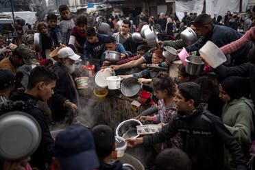 Palestinians line up for a free meal in Rafah, Gaza Strip, December 21, 2023. (AP)
