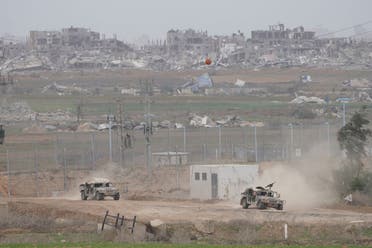 Israeli army vehicles are seen near the Gaza Strip border, in southern Israel, December 23, 2023. (AP)