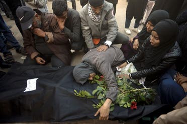 Palestinians mourn relatives killed in the Israeli bombardment of the Gaza Strip outside a morgue in Khan Younis on December 24, 2023. (AP)