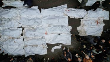 Mourners gather next to the bodies of Palestinians killed in Israeli strikes, amid the ongoing conflict between Israel and Hamas, at a hospital in the central Gaza Strip, December 25, 2023. (Reuters)