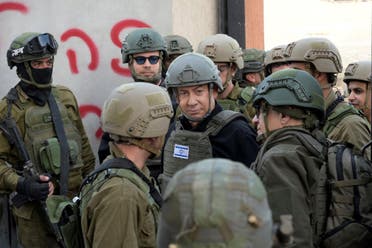 Israeli Prime Minister Benjamin Netanyahu, center, wears a protective vest and helmet as he receives a security briefing with commanders and soldiers in the northern Gaza Strip, December 25, 2023. (Handout via AP)