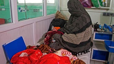 In this photograph taken on December 8, 2023, Islam Bibi, mother of six children and newborn triplets, sits beside her three babies at the Doctors Without Borders (MSF)-run maternity hospital in Khost. (AFP)