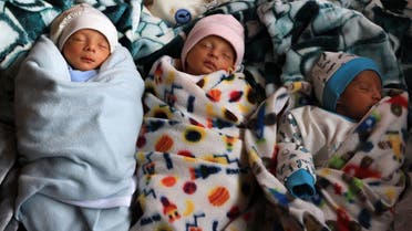 Three of the al-Masri quadruplets - the fourth still being treated in hospital - belonging to Ammar and Iman al-Masri, displaced Palestinians who fled from Beit Hanoun to escape Israeli bombardment, sleep as they shelter at a school in Deir al-Balah in the central Gaza Strip on December 27, 2023, amid continuing battles between Israel and the militant Hamas group. (AFP)