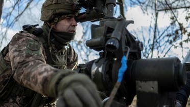 A Ukrainian soldier points an M777 howitzer to fire toward Russian troops near the front line town of Marinka in Donetsk region of Ukraine on December 26, 2023. (REUTERS)