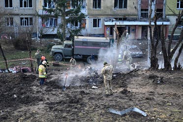 Ukrainian servicemen inspect the remains of a missile in the yard of a damaged building after a missile attack in Lviv, western Ukraine, on December 29, 2023. (AFP)