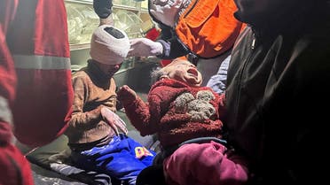 Palestinian girl Mariam Abu Akel and her brother Hamed, who were rescued from under the rubble of a house hit by an Israeli strike, amid the ongoing conflict between Israel and Hamas, receive medical attention inside an ambulance, in Rafah in the southern Gaza Strip, on December 29, 2023. (Reuters)