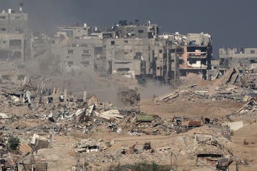 A picture taken from a position in southern Israel along the border with the Gaza Strip shows a military vehicle driving inside Gaza on December 29, 2023, amid continuing battles between Israel and Hamas. (AFP)