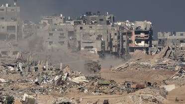 A picture taken from a position in southern Israel along the border with the Gaza Strip shows a military vehicle driving inside Gaza on December 29, 2023, amid continuing battles between Israel and Hamas. (AFP)