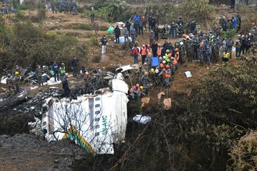 Rescuers pull the body of a victim who died in a Yeti Airlines plane crash in Pokhara on January 16, 2023. (AFP)