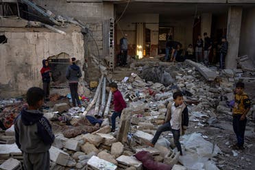 Palestinians look at the destruction after an Israeli strike in Rafah, southern Gaza Strip, December 29, 2023. (AP)