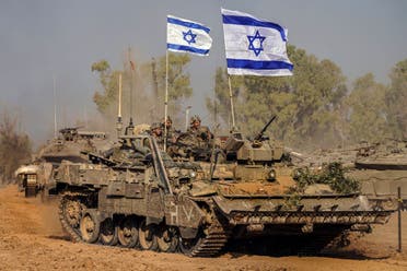 Israeli army vehicles arrive to a staging area after combat in the Gaza Strip in southern Israel, December 30, 2023. (AP)