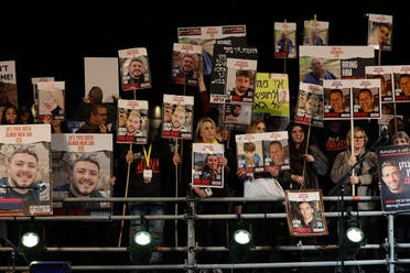 Relatives and supporters hold placards bearing portraits of Israeli hostages held in Gaza since the October 7 attacks by Hamas in southern Israel, during a rally calling for their release, in Tel Aviv on December 30, 2023. (AFP)
