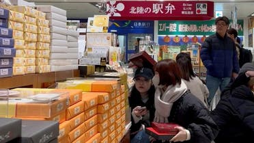 People sit on the floor as items fall from shelves on the ground inside a store as an earthquake hits, in Kanazawa, Ishikawa, Japan January 1, 2024, in this screengrab obtained from a social media video. (Reuters)