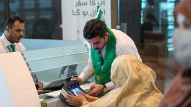 In this file photo, taken on June 13, 2023, Saudi official facilitates Pakistani Hajj pilgrim during biometrics at the immigration counter at the Islamabad International Airport. (Photo courtesy: Twitter/MakkahRoute)