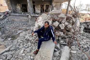Palestinian man Hamada Abu Sleyma, whose wife, all his 6 children and two grandchildren were killed in an Israeli strike that destroyed his house, sits on the rubble of his house, in Rafah in the southern Gaza Strip, on January 1, 2024. (Reuters)