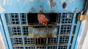 FTR MOVING TUESDAY APRIL 1 - The hand of a Palestinian inmate is seen in a prison in the West Bank city of Nablus February 11, 2008. Many of the Palestinian Authority's prisons, some dating back to the Ottoman era, were destroyed by Israel after a Palestinian uprising erupted in 2000 and peace talks broke down.The few prisons that Israel left standing and the dysfunctional Palestinian judicial system, plagued by backlogs long before Prime Minister Salam Fayyad launched his security crackdown last November, can't cope with the influx. Picture taken February 11, 2008. To match feature PALESTINIANS-ISRAEL/PRISONS. REUTERS/Eliana Aponte (WEST BANK)