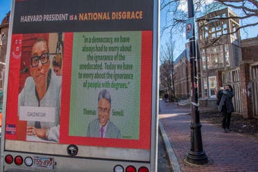 A truck calling the president of Harvard a disgrace drives around Harvard University in Cambridge, Massachusetts on December 12, 2023. (AFP)