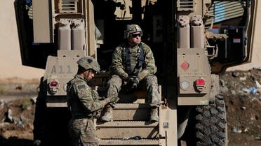  US army soldiers sit next a military vehicle in the town of Bartella, east of Mosul, Iraq, on December 27, 2016. (Reuters)