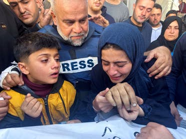 Al Jazeera journalist Wael al-Dahdouh hugs his daughter and son as they attend the funeral of his son, Palestinian journalist Hamza al-Dahdouh, after Hamza was killed in an Israeli strike, in Rafah in the southern Gaza Strip, January 7, 2024. (Reuters)