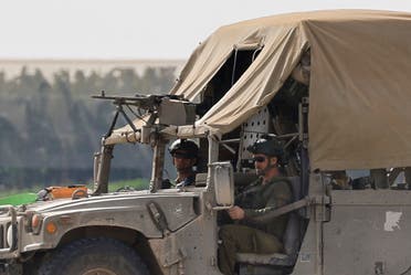 Members of the Israeli military sit in a vehicle near the Israel-Gaza border, amid the ongoing conflict between Israel and Hamas, as seen from southern Israel, January 8, 2024. (Reuters)