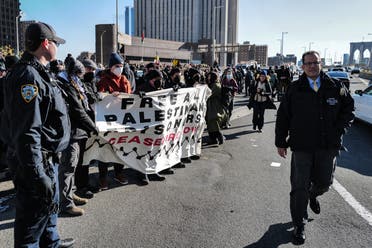 NYPD officers arrest pro-Palestinian protesters as they gathered and blocked the Manhattan entrance of the Brooklyn bridge in New York City on January 8, 2024. (AFP)