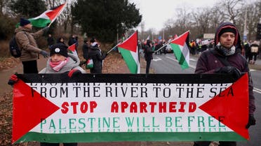 Pro-Palestinian demonstrators hold a banner as they protest near the International Court of Justice (ICJ) on the day judges hear a request for emergency measures to order Israel to stop its military actions in Gaza, in The Hague, Netherlands January 11, 2024. REUTERS/Thilo Schmuelgen
