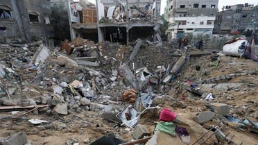 Palestinians look at the destruction after an Israeli strike at a residential building in Deir al Balah, Gaza Strip, Jan. 14, 2024. (AP)