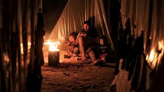 Gaza’s displaced families battle harsh winter with makeshift tents, burning waste