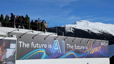 People gather on top of Tata Consultancy Services pavilion on which a slogan related to Artificial Intelligence (AI) is displayed, during the 54th annual meeting of the World Economic Forum in Davos, Switzerland, January 16, 2024. (Reuters)