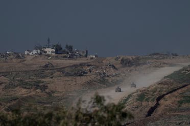 Israeli military vehicles leave the Gaza Strip, as seen from southern Israel, on January 19, 2024. (AP)