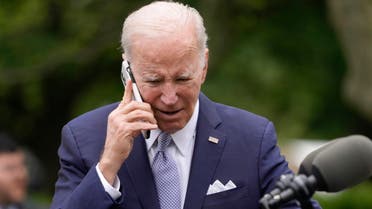 President Joe Biden talks on a phone after speaking in the Rose Garden of the White House in Washington, Monday, May 1, 2023, about National Small Business Week. (AP Photo/Carolyn Kaster)