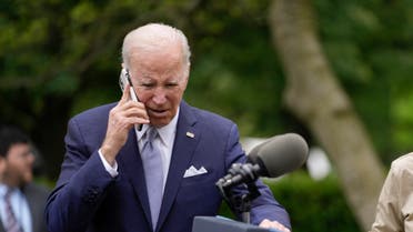 President Joe Biden talks on a phone after speaking in the Rose Garden of the White House in Washington, Monday, May 1, 2023, about National Small Business Week. (AP Photo/Carolyn Kaster)
