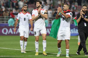 Palestine's players greet their supporters after the Qatar 2023 AFC Asian Cup Group C football match between Hong Kong and Palestine at the Abdullah bin Khalifa Stadium in Doha on January 23, 2024. (AFP)