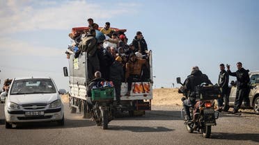 Palestinians ride a truck with some of their belongings as they flee Khan Younis toward Rafah further south in the Gaza Strip, on January 25, 2024, amid continuing battles between Israel and Hamas. (AFP)