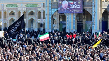 This handout picture provided by the Iranian presidency on January 5, 2024, shows people attending the funeral of victims killed in twin blasts on January 3, as they took part in a commemoration marking the anniversary of the killing of IRGC commander Qassem Soleimani (on banner) in the southern city of Kerman. (AFP)