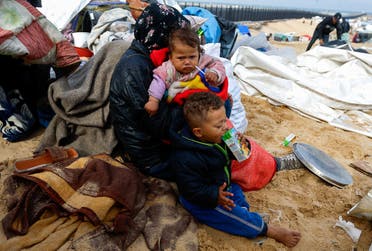 Children look on as Palestinians fleeing Khan Younis due to the Israeli ground operation arrive in Rafah, amid the ongoing conflict between Israel and Hamas, in the southern Gaza Strip, on January 26, 2024. (Reuters)