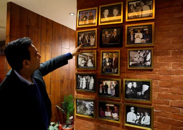 Moti Mahal Delux Managing Director Monish Gujral shows photographs of celebrities and politicians inside the restaurant in New Delhi, India, January 23, 2024. (Reuters)