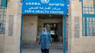 A Palestinian health worker leaves a health center run by the United Nations Relief and Works Agency (UNRWA), at al-Fari'ah refugee camp, in the Israeli-occupied West Bank April 8, 2021. REUTERS/Raneen Sawafta