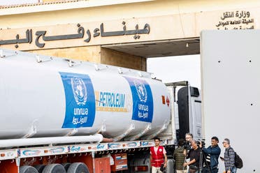 Media representatives work as a truck carrying humanitarian aid from the United Nations Relief and Works Agency for Palestine Refugees (UNRWA) arrives at the Egyptian side of the Rafah border crossing with the Gaza Strip on November 22, 2023, amid ongoing battles between Israel and the Palestinian militant group Hamas. (Photo by Khaled DESOUKI / AFP)