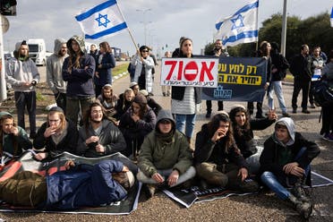 Israeli right-wing activists block the exit of Ashdod port to stop trucks they claim are carrying humanitarian aid for the Gaza Strip, in the coastal city of Ashdod, on February 1, 2024, amid ongoing battles between Israel and Hamas. (AFP)