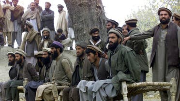 Captured Afghan al Qaeda members sit on a bench as they are presented to the media in Tora Bora, in this file picture taken December 17, 2001. Al Qaeda leader Osama bin Laden was killed May 1, 2011 in a firefight with U.S. forces in Pakistan and his body was recovered, President Barack Obama said on Sunday. Justice has been done, Obama said in a dramatic, late-night White House speech announcing the death of the elusive mastermind of the Sept. 11, 2001, attacks on New York and Washington that killed nearly 3,000 people. Bin Laden had been hunted since he eluded U.S. soldiers and Afghan militia forces in a large-scale assault on the Tora Bora mountains of Afghanistan close to the Pakistan frontier in 2001. REUTERS/Erik de Castro (AFGHANISTAN - Tags: CIVIL UNREST)