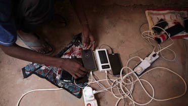 People gather at the home of a volunteer, where they can charge their mobile phones, in Khartoum, Sudan, Thursday, May 25, 2023. The U.N. migration agency said Wednesday that the fighting between Sudan's military and a powerful paramilitary force had displaced more than a million people. (AP Photo)